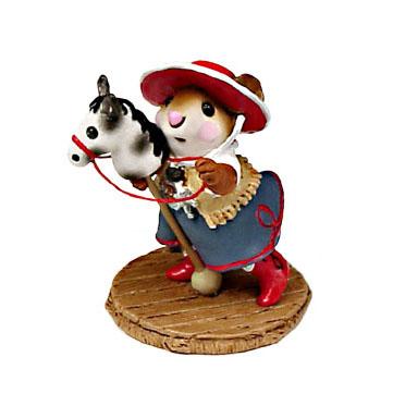 Cow girl riding a toy horse
