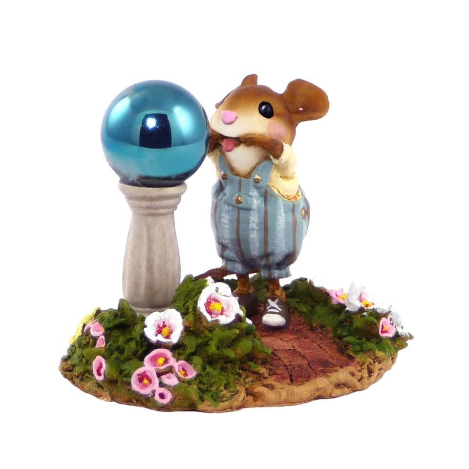 A Mouse Making a Funny Face in a Garden Ball